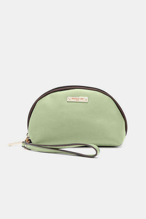 a small green purse with a brown strap