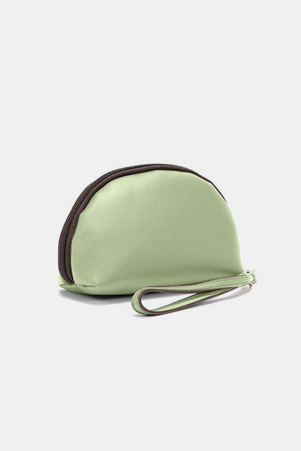a small green purse sitting on top of a white table