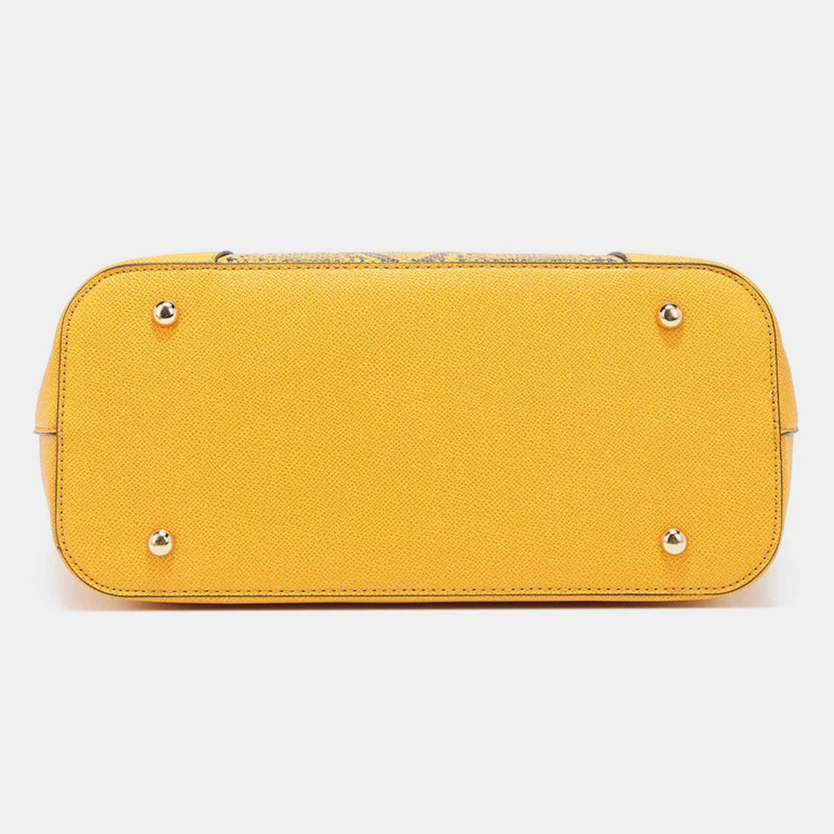 a yellow purse with rivets on the front