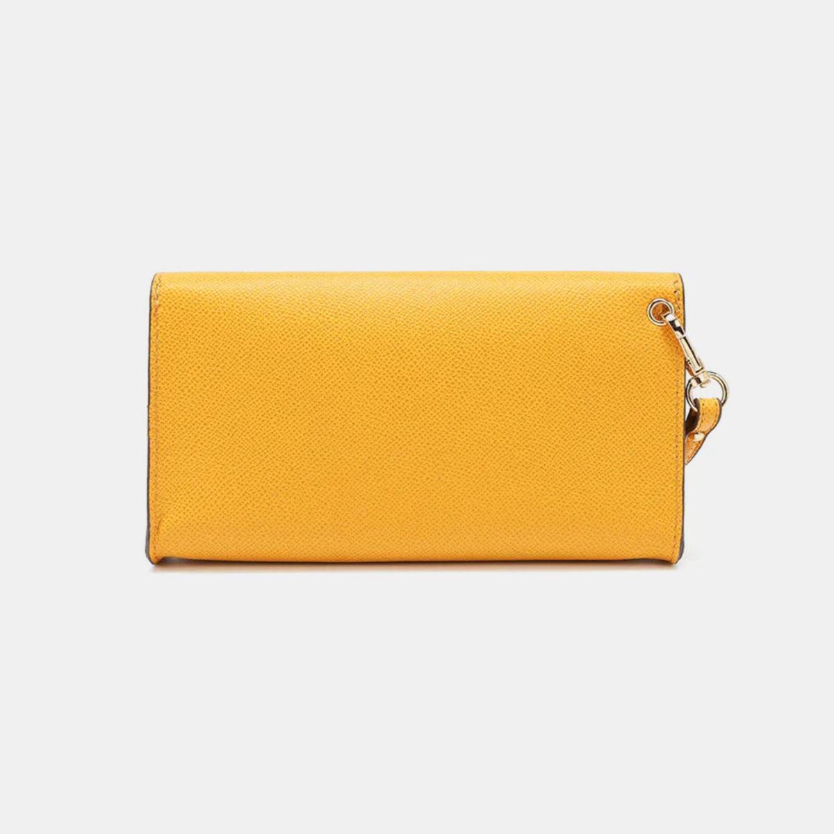 a yellow wallet with a chain hanging from it