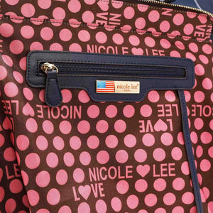 a polka dot purse with a name tag on it