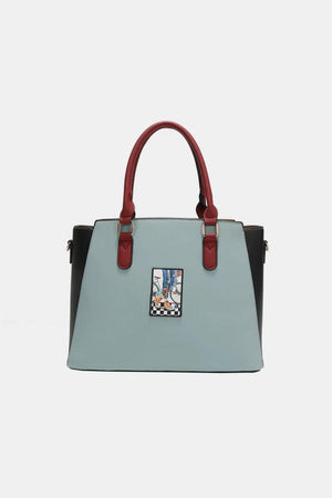 a blue and black handbag with a red handle