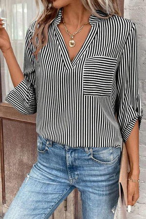 a woman wearing a black and white striped shirt