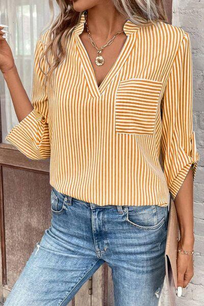 a woman wearing a yellow and white striped shirt