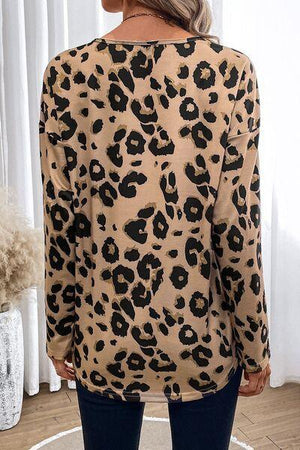 a woman wearing a leopard print top