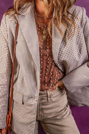 a woman wearing a hat and jacket posing for a picture
