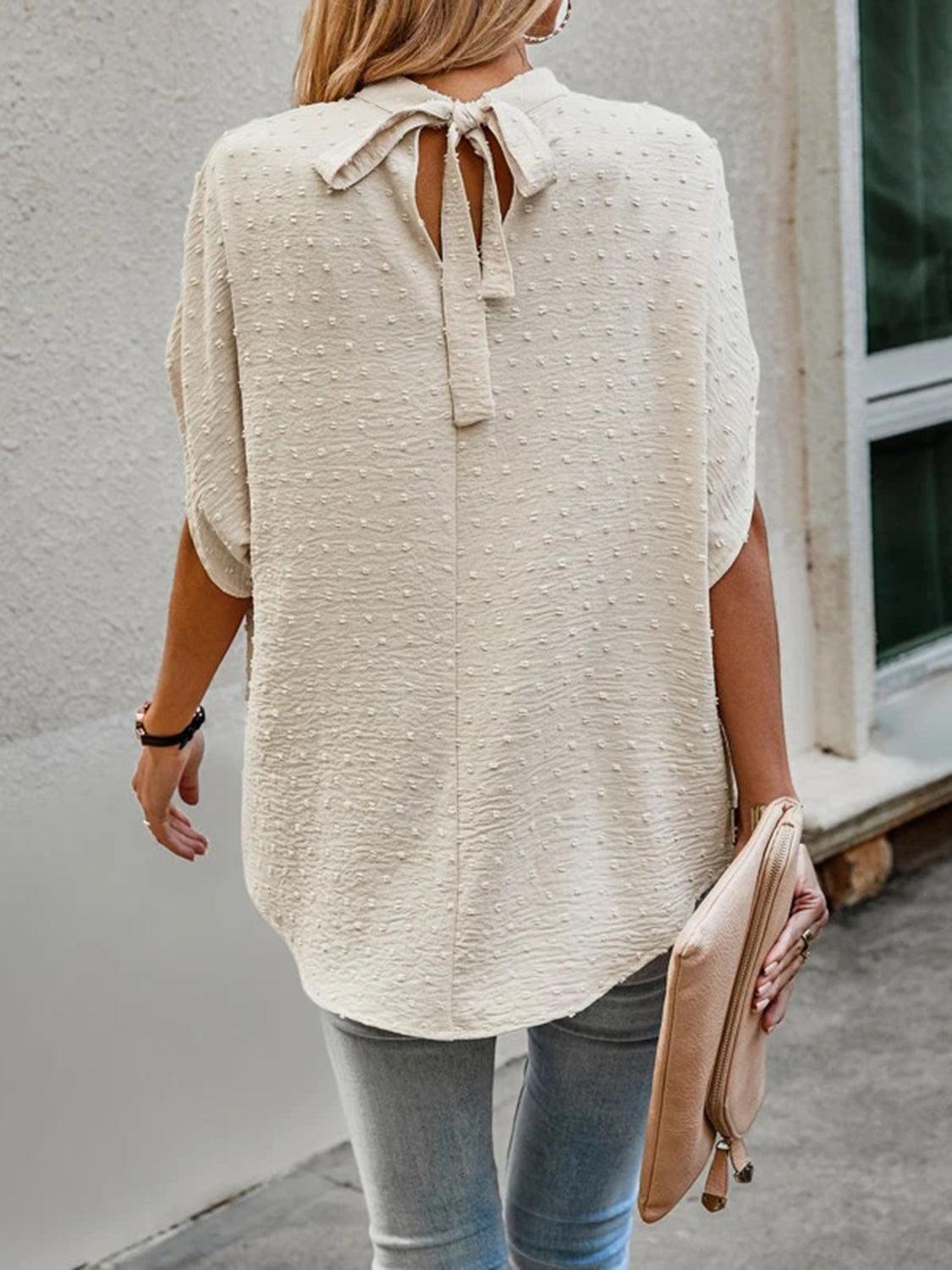 a woman walking down a street with a purse