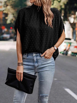 a woman wearing ripped jeans and a black top