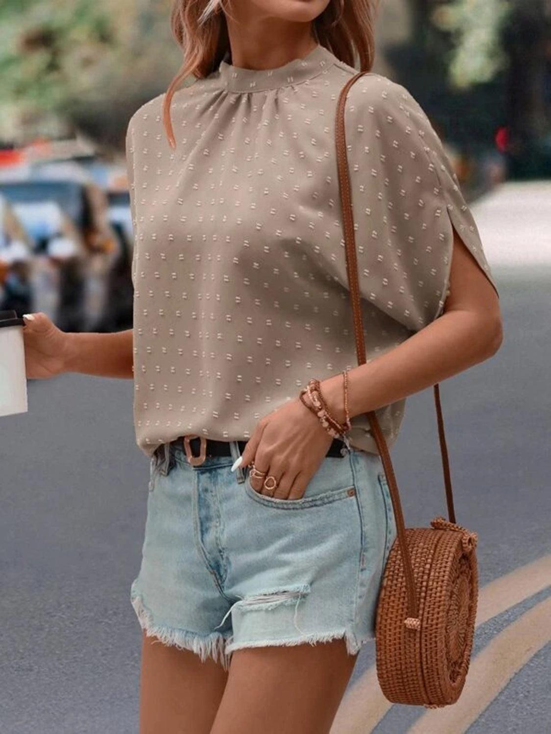 a woman is walking down the street holding a coffee cup
