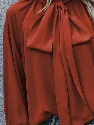 a woman with blonde hair wearing a red blouse