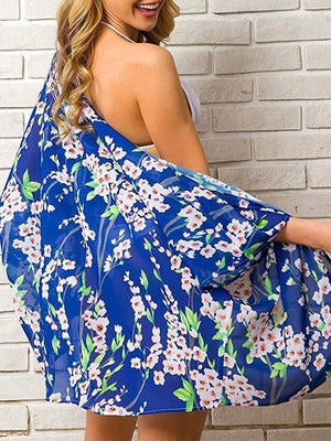 a woman wearing a blue floral print dress