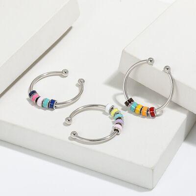 a pair of hoop earrings with multi colored beads