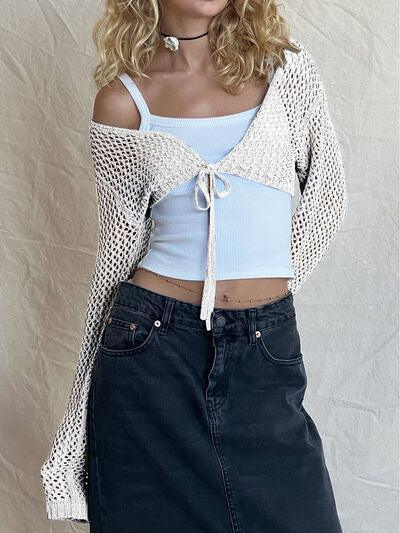 a woman wearing a blue top and a black skirt