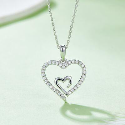 a heart shaped diamond pendant on a chain