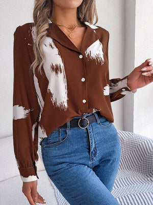 a woman wearing a brown and white shirt and jeans