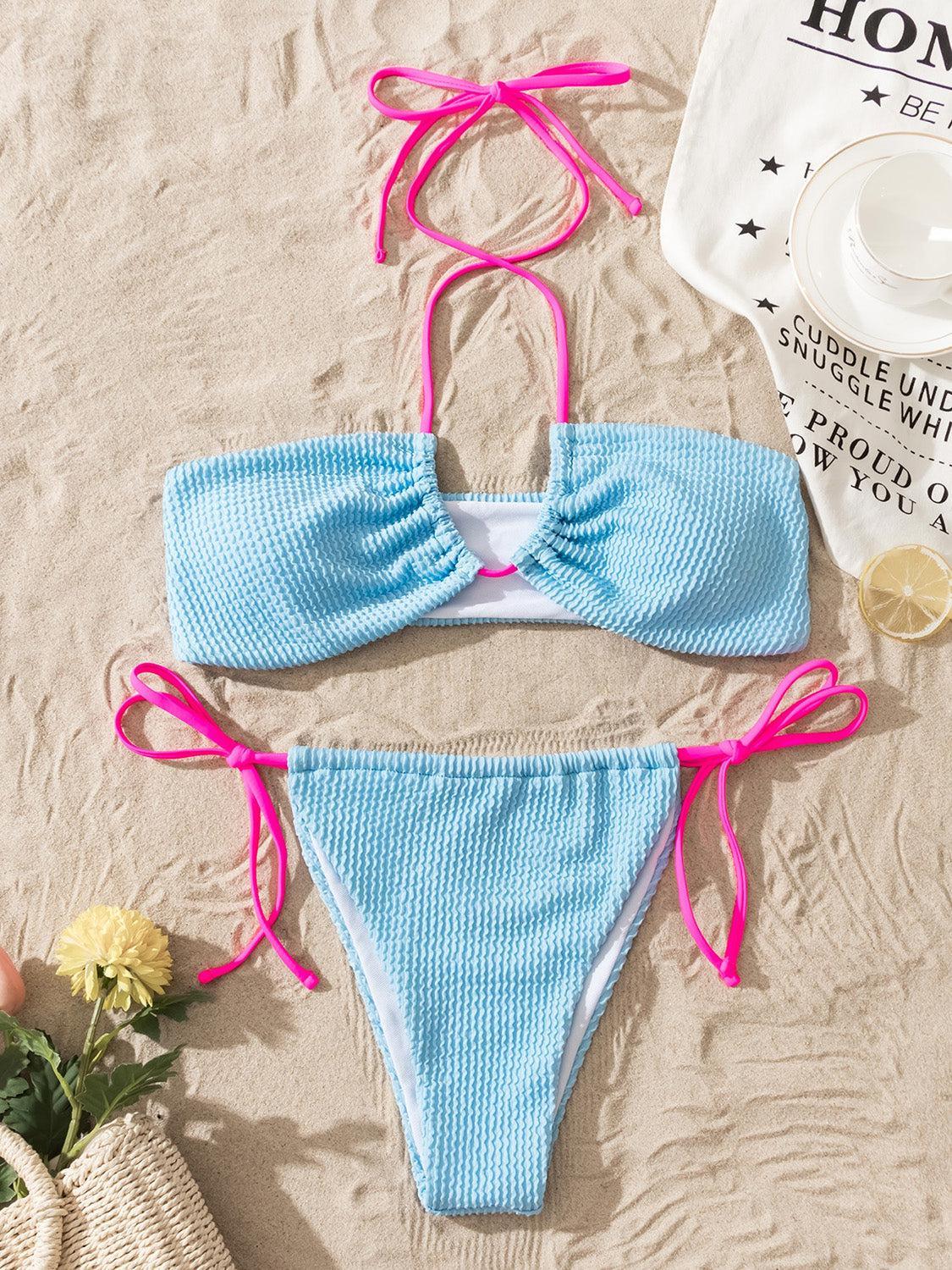 a bikini top with a pink bow on it