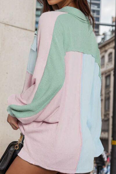 a woman in a pink, blue, and green sweater