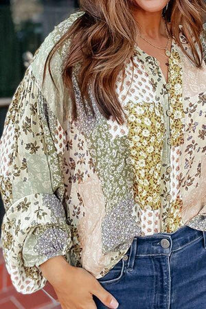 a woman wearing a floral blouse and jeans