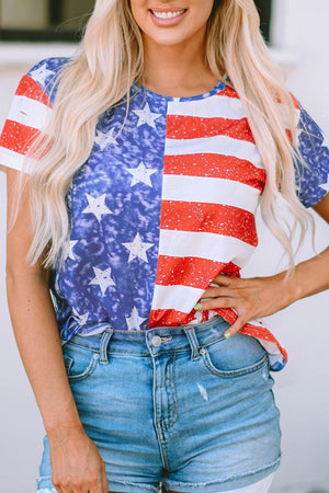 a woman wearing a patriotic shirt and denim shorts