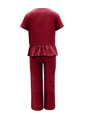 a woman wearing a red top and pants