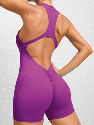 a woman in a purple bodysuit with her hands on her hips