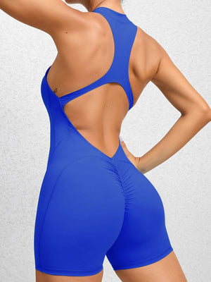 a woman in a blue swimsuit with her back to the camera