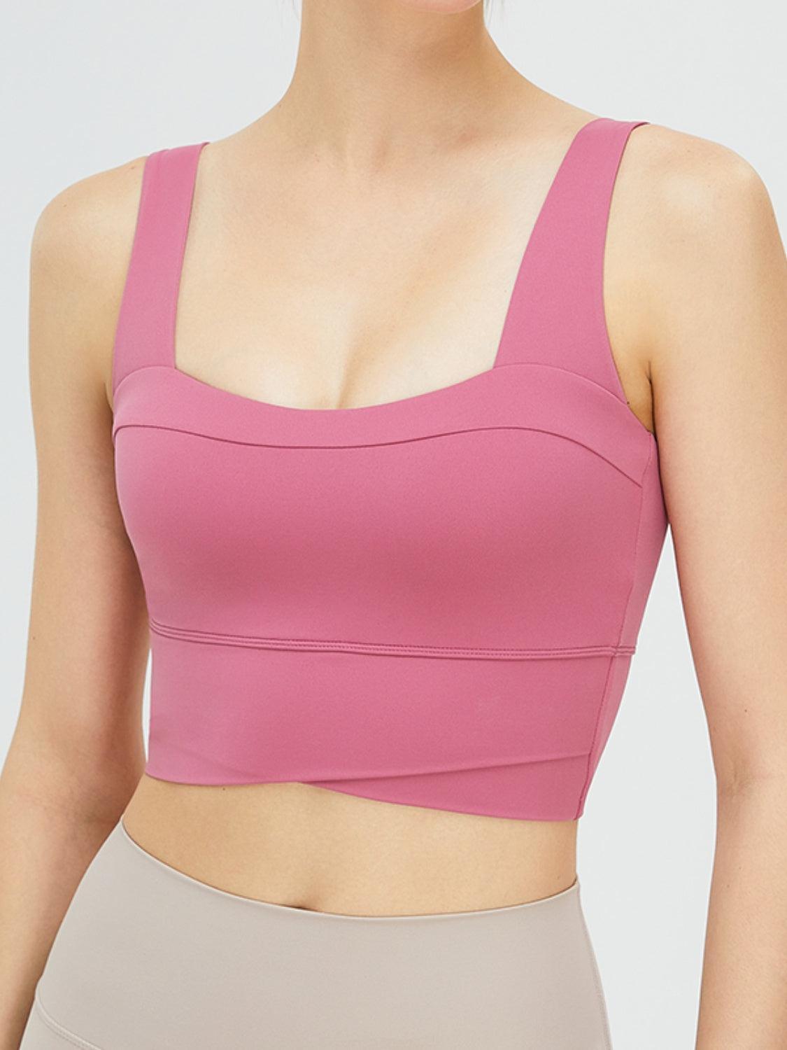 a woman wearing a pink sports bra top