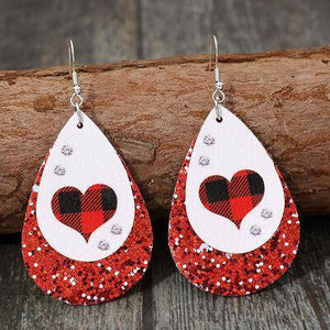 a pair of red and white heart shaped earrings