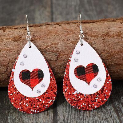a pair of red and white heart shaped earrings