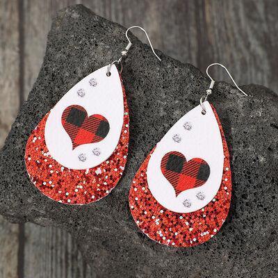 a pair of red and white heart shaped earrings