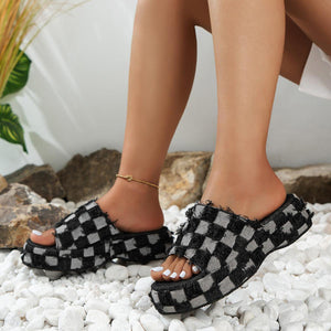 a woman wearing black and white checkered sandals
