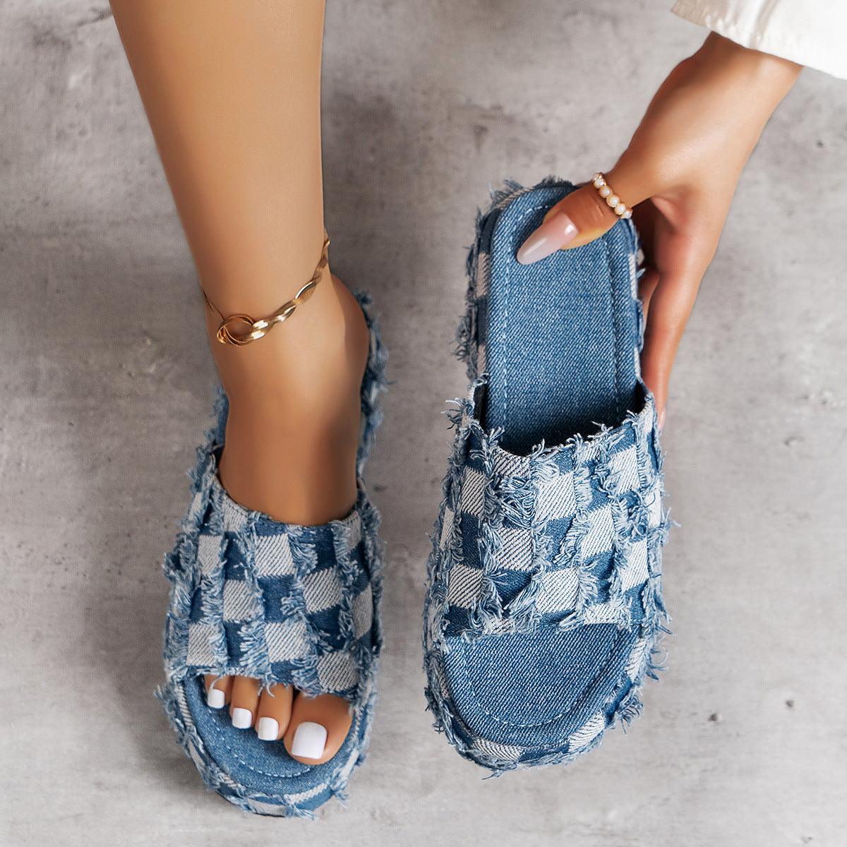 a woman's feet wearing a pair of denim sandals