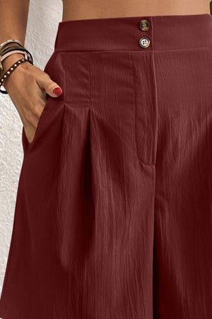 a woman wearing a red skirt and a white top