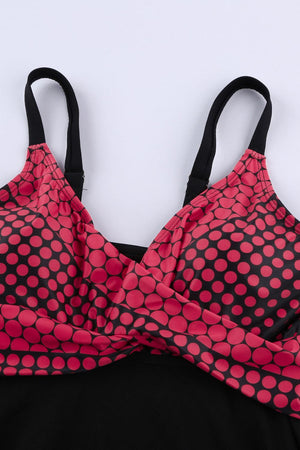 a pink and black polka dot bra with black straps
