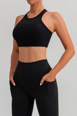 a woman in a black sports bra top and leggings
