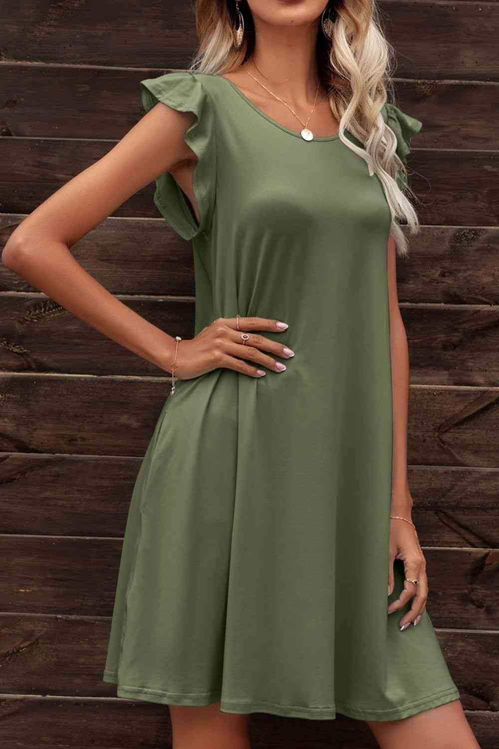 a woman in a green dress posing for the camera