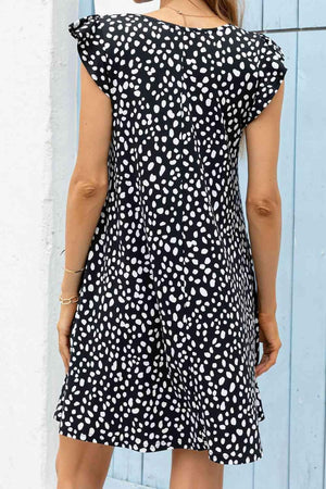 a woman wearing a black and white polka dot dress