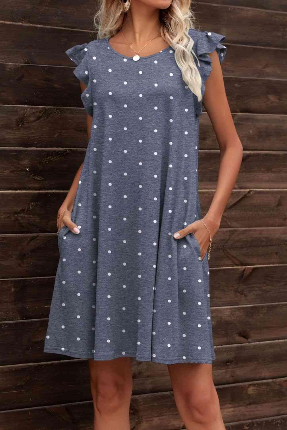 a woman standing in front of a wooden wall