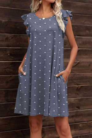 a woman standing in front of a wooden wall