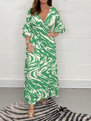 a woman in a green and white dress