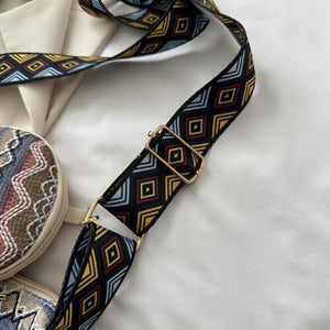 a pair of shoes and a bag on a bed