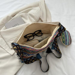 a purse with a pair of glasses inside of it