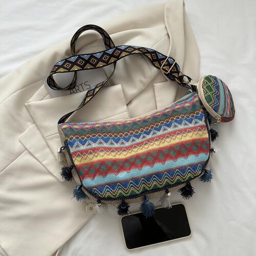 a multicolored bag with a tag and a pair of sunglasses