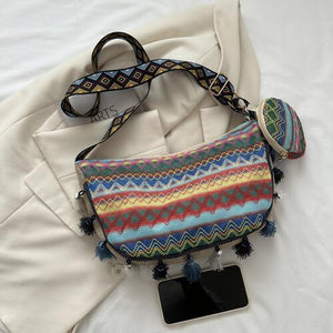 a multicolored bag with a tag and a pair of sunglasses