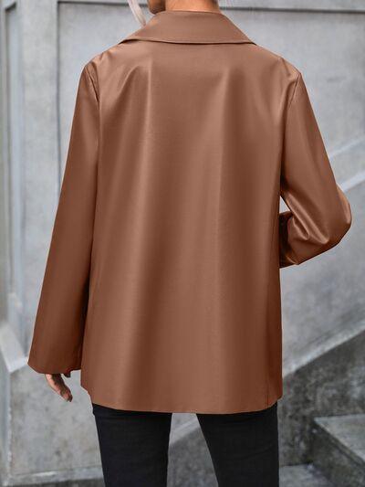 a man wearing a brown jacket and black pants