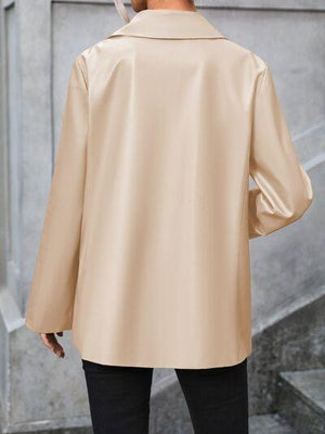 a man in a beige jacket is standing outside