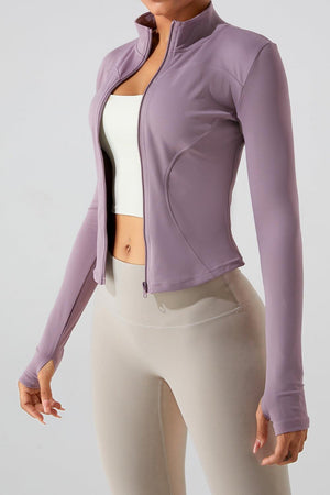 a woman wearing a purple jacket and white top