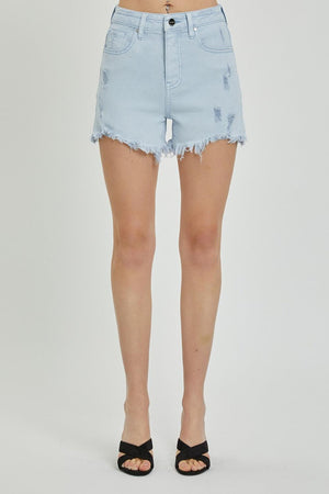 a woman wearing a pair of light blue denim shorts