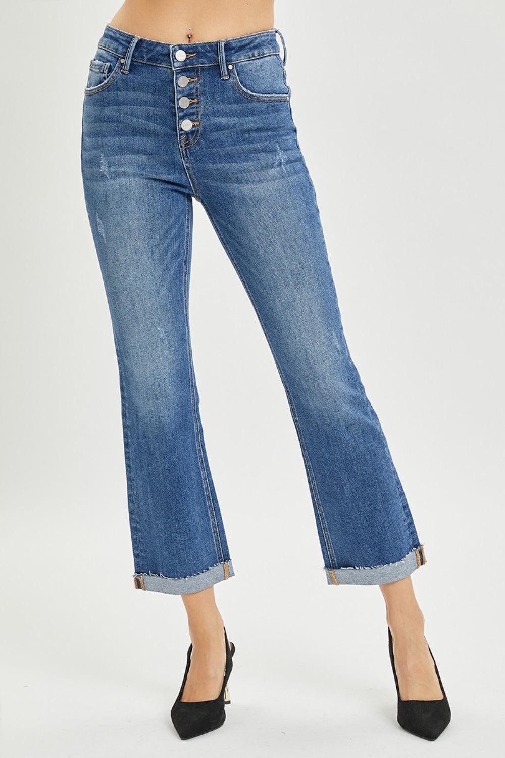a woman wearing high rise jeans and heels