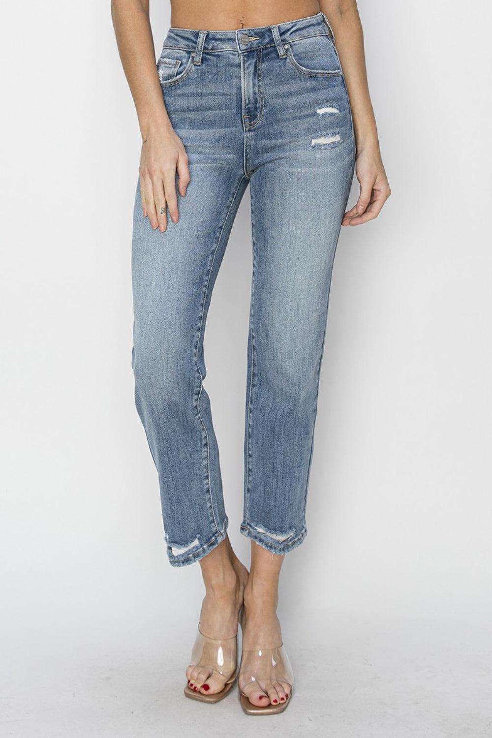 a woman wearing a crop top and jeans